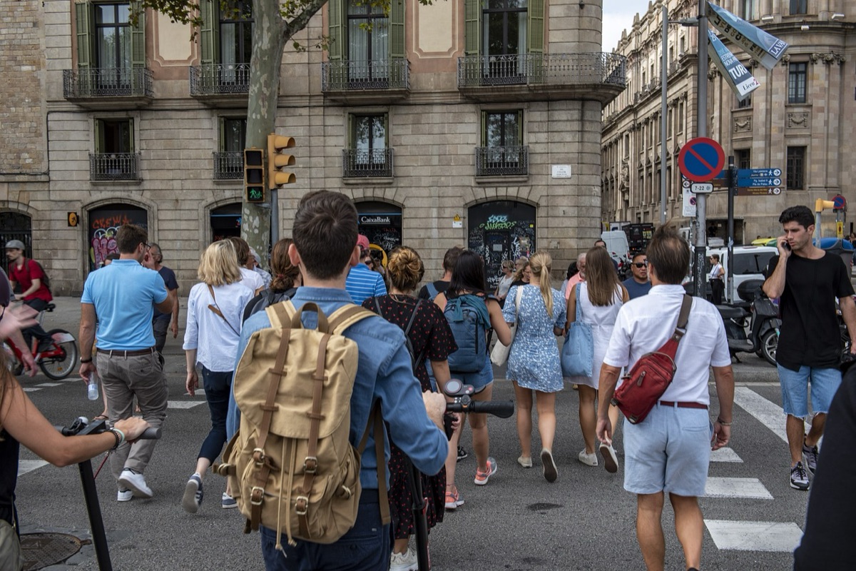 Barcelona tourist in crowded market with backpack