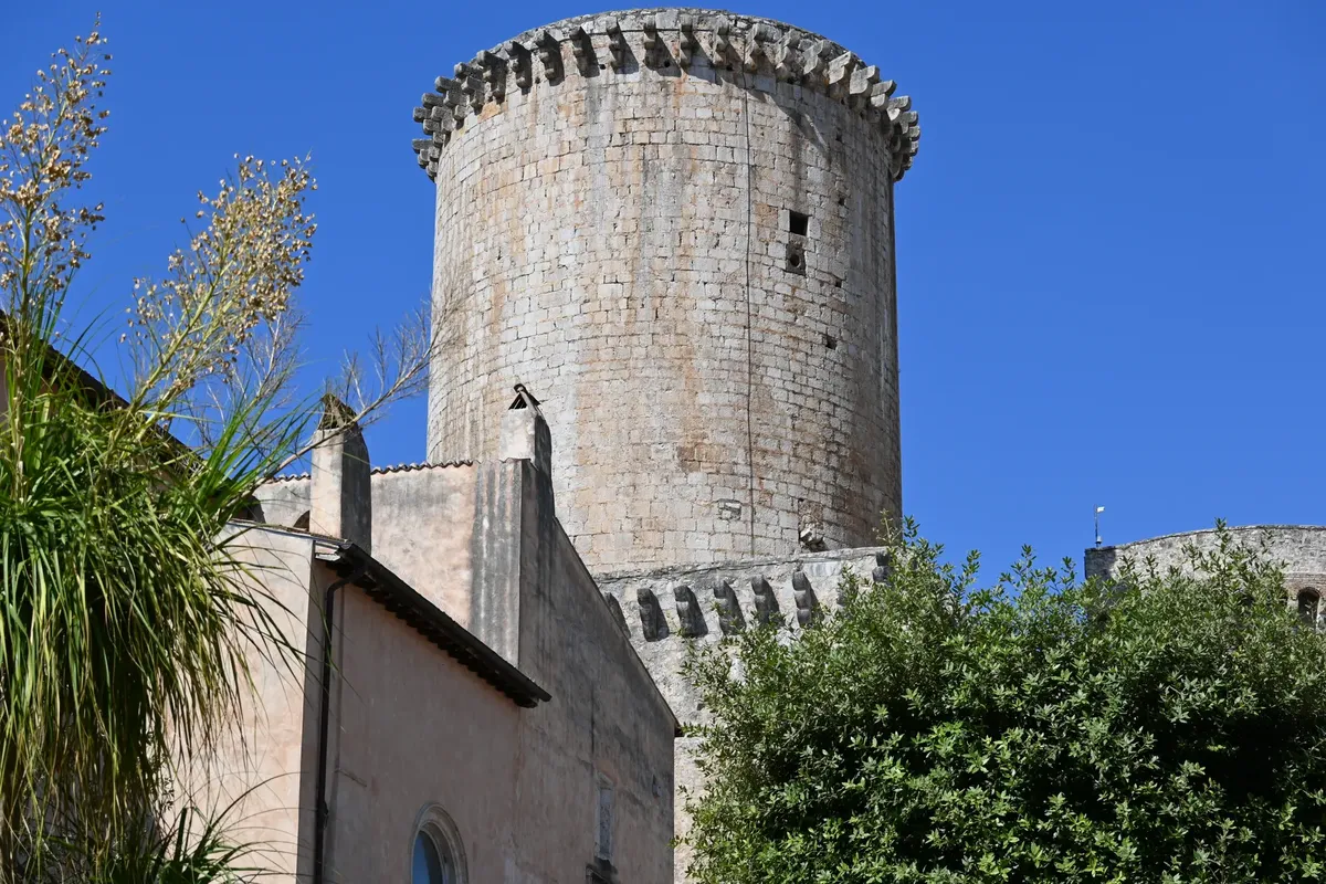 Stunning view of a medieval tower in Fondi, Latium, Italy with clear blue sky.