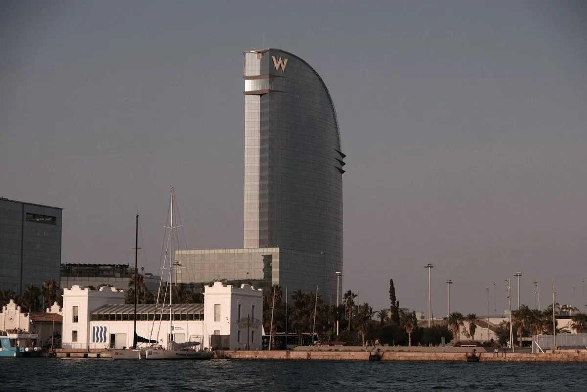 Scenic view of sailboats near the W Barcelona Hotel during a tranquil sunset.